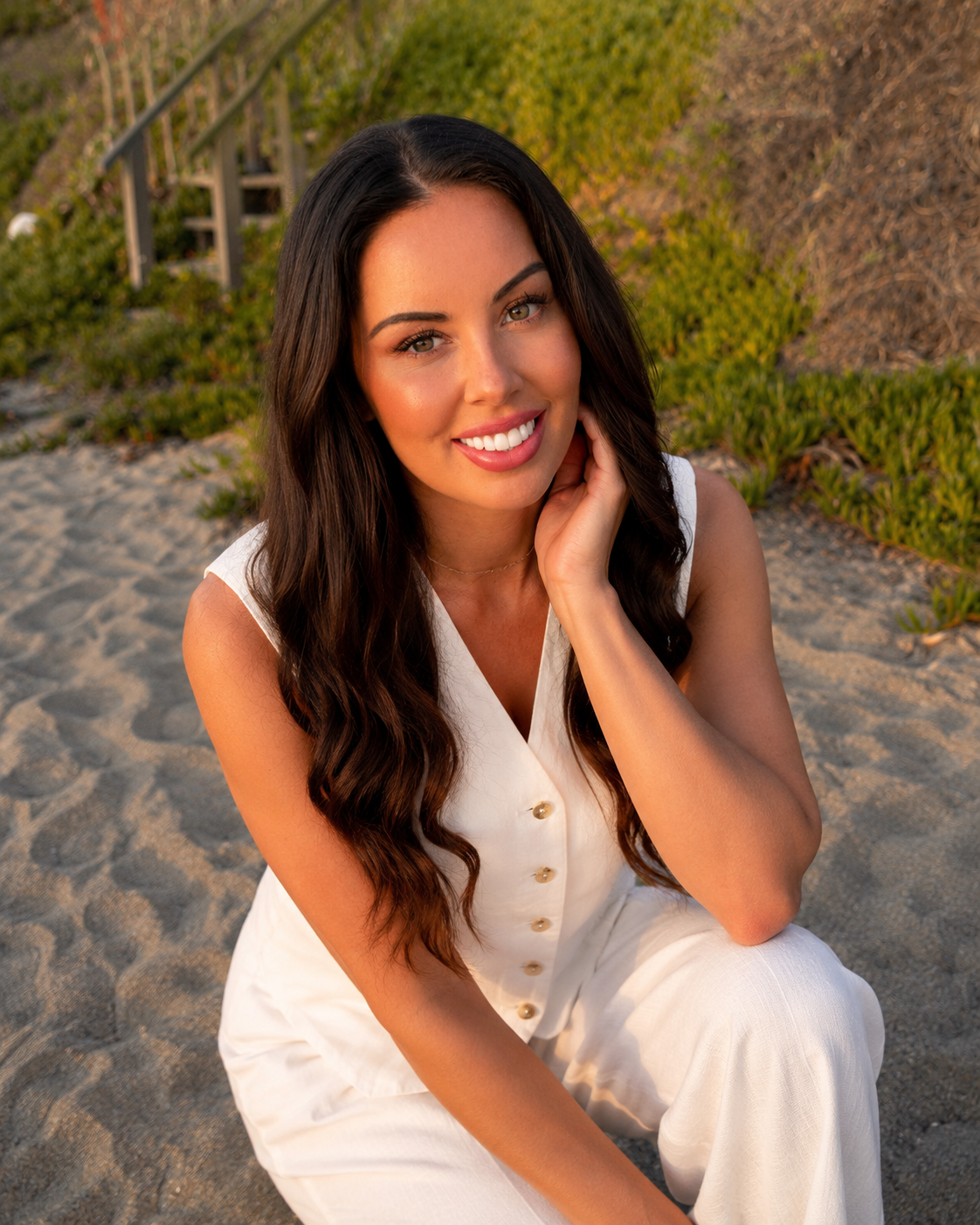 Laura Picard seated on the beach in warm natural light